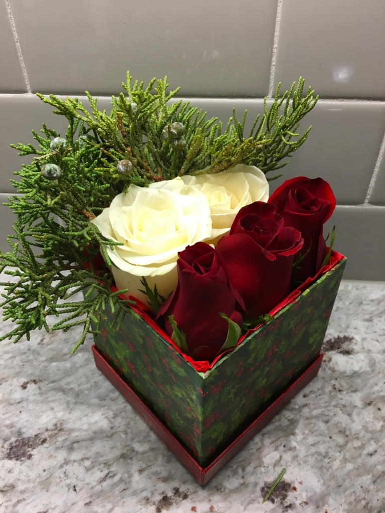 Christmas flowers in a box, red roses, pine, bruni berries