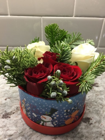 Christmas flowers in a box, red roses, pine, bruni berries