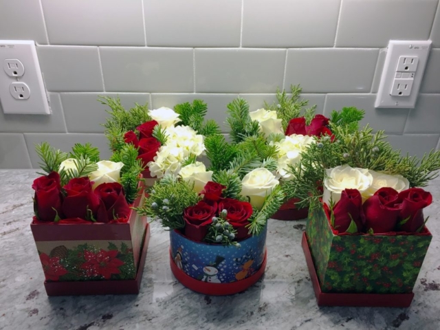 Christmas flowers in a box, red roses, pine, bruni berries